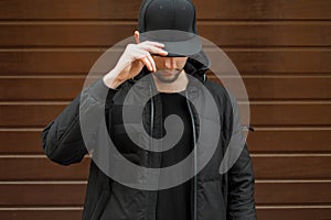 Young man in a black fashionable baseball cap