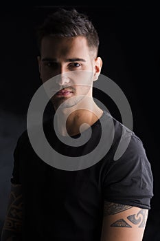 Young man with black t-shirt and tattoos