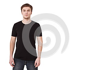 Young man in blank black tshirt isolated on white background. Copy space. Place for advertisement. Front view of T-shirt.