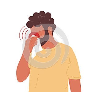 Young man blowing nose into handkerchief