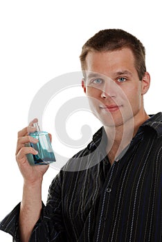 Young man with a blue cologne bottle