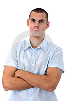 Young man in blue shirt with arms crossed isolated