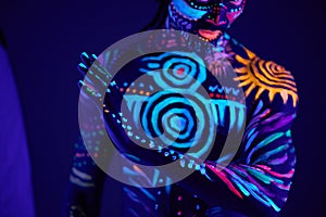 Young man blur with ultraviolet body art