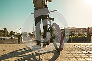 Young man with a bmx bike and a backpack in the city