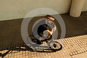 Young man with a bmx bike on the street