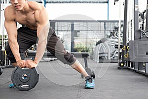 Young man bodybuilder execute exercise in fitness center. male a