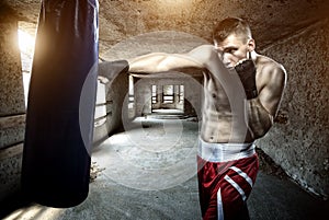 Young man boxing workout in an old building