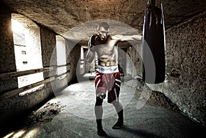 Young man boxing workout in an old building