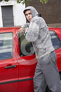 Young Man Breaking Into Car