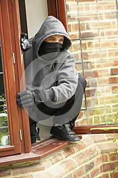 Young Man Breaking Into House