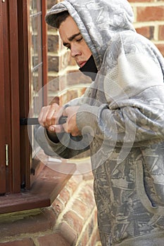 Young Man Breaking Into House