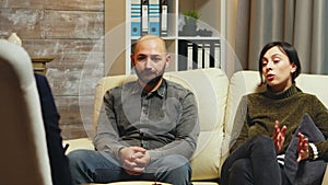 Young man breathing heavily sitting on couch