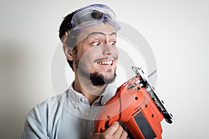 Young man bricolage working with electric saw