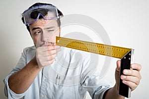 Young man bricolage working measuring with meter