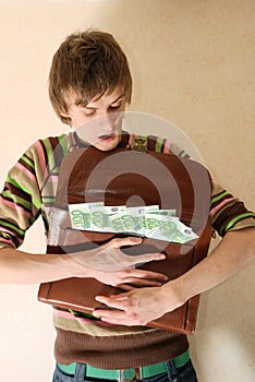 Young man with briefcase full of money