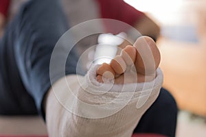 Young man with a broken ankle and a leg cast