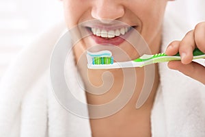 Young man brushing teeth, closeup
