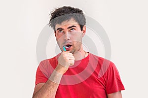 Young man brushing teeth in the morning