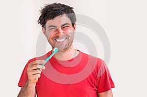 Young man brushing teeth in the morning