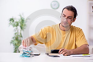 Young man in budget planning concept