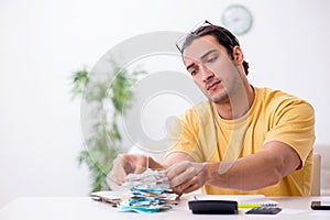 Young man in budget planning concept