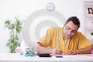 Young man in budget planning concept