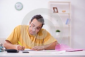 Young man in budget planning concept