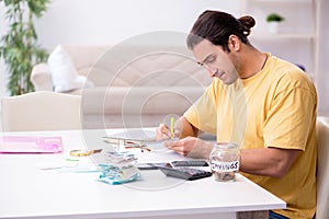 Young man in budget planning concept