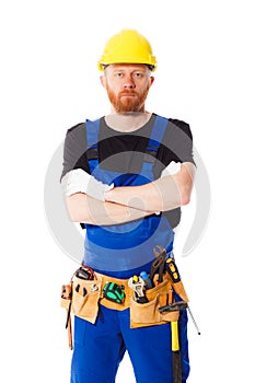 Young man builder with belt of construction tools