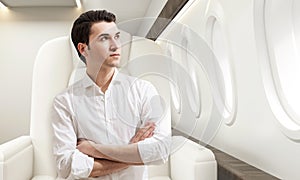 Young man in business class of a plane