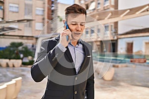 Young man business worker smiling confident talking on smartphone at park