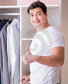 Young man businessman getting dressed for work