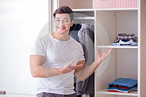 The young man businessman getting dressed for work