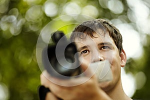 Young man with camcorder