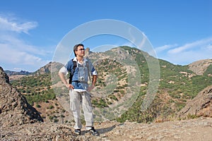 Young man with camera on top of Karadag mountain