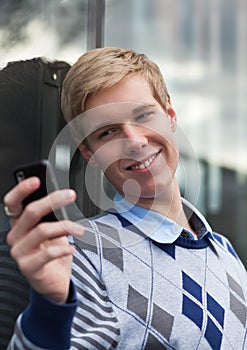 Young man with cameraphone