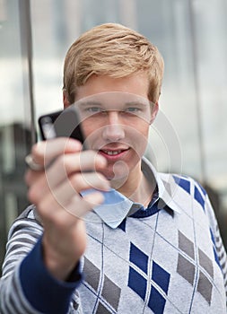 Young man with cameraphone