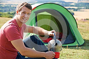 Young Man Camping In Countryside