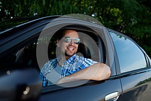 Young man in car smiling
