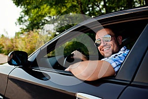 Young man in car smiling