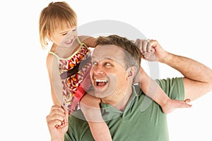 Young man carries child on shoulders photo