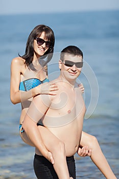 Young man carries girl