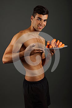 Young man with carrots