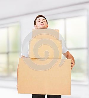 Young man carrying carton boxes