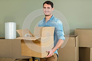 Young man carrying carton boxes