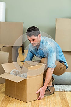 Young man carrying carton boxes