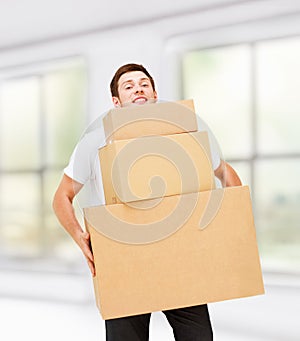 Young man carrying carton boxes