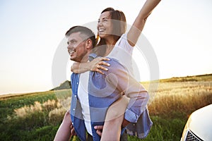 Young man carrying girlfriend on his shoulders