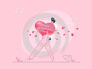 Young man carrying heavy Valentines greeting card