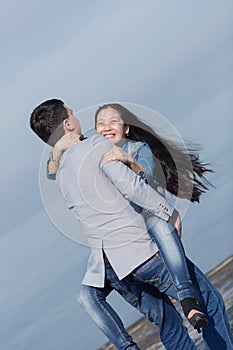 Young man carrying his asian girl